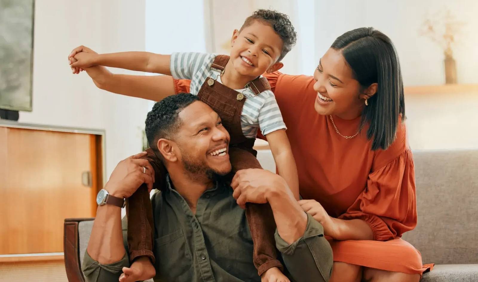 a family of three playing in their new house