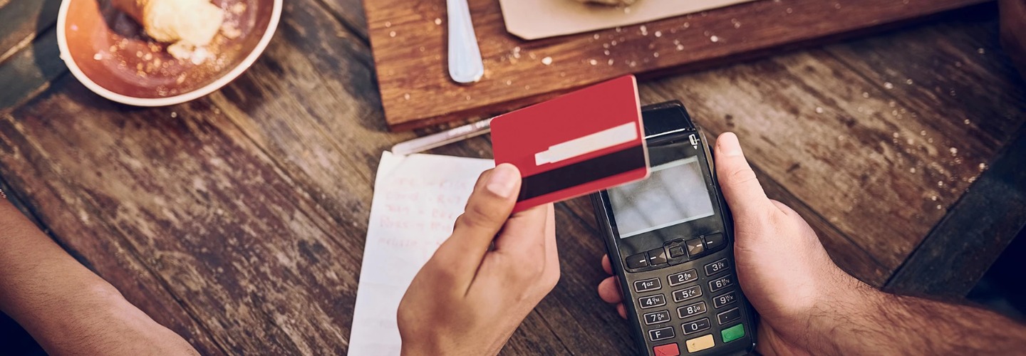 a person making a debit and credit card purchase