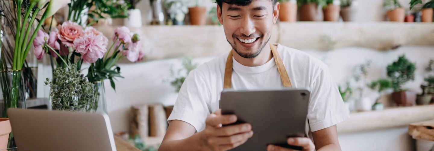 a flower shop owner viewing his tablet