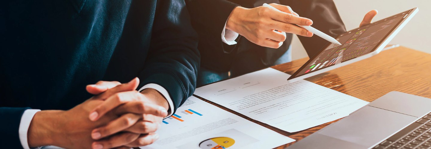 Two people reviewing financial documents