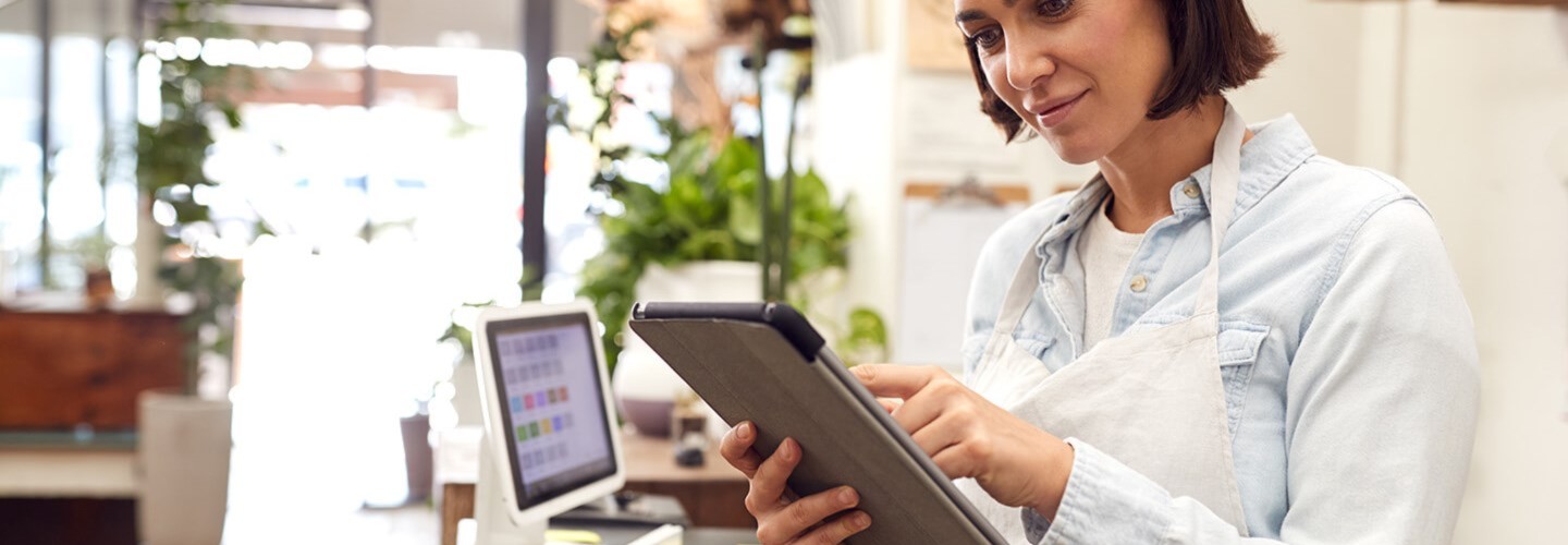 a small business owner viewing her tablet