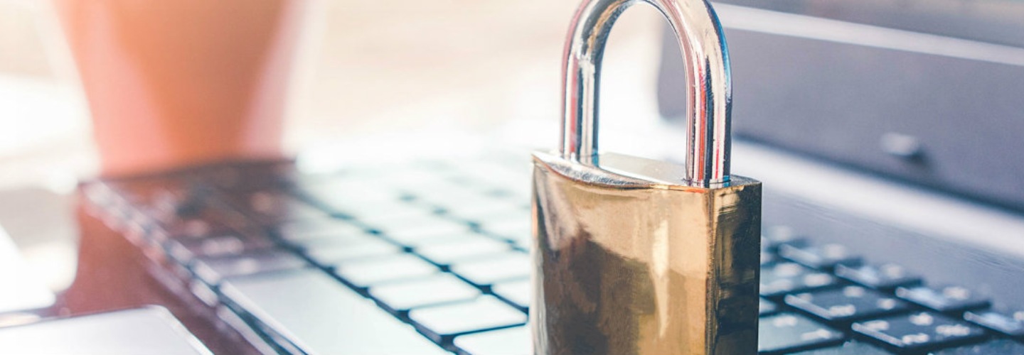 a bronze padlock on a keyboard